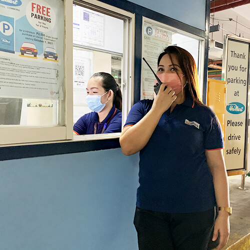 Woman Parking Attendant and Cashier on Duty