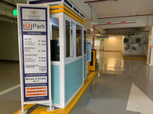 Somerset Salcedo UPark's entrance and exit cashier with parking rates and schedule displayed infront