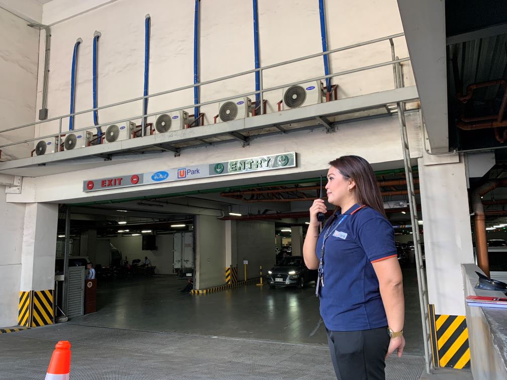 Upark cashier staff standing by parking entrance