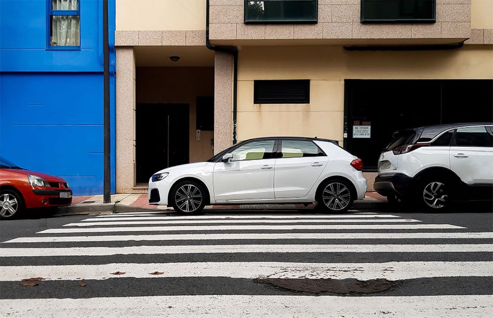 car illegally parked on pedestrian lane