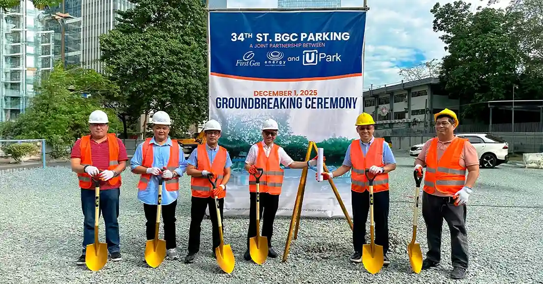 Six construction workers wearing safety helmets and orange vests hold golden shovels during a groundbreaking ceremony for UPark 34th Street BGC, with a banner behind them reading ‘New Era of Parking Begins – December 1, 2025 Groundbreaking Ceremony